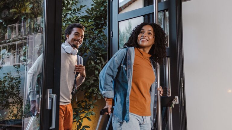 Two People Smiling at the Entrance