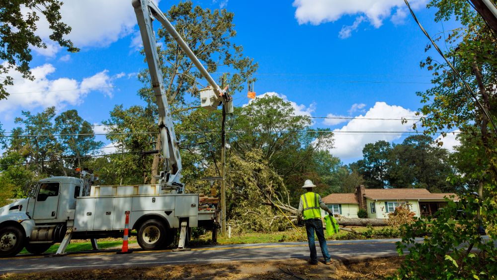 Worker repairing an electrical utility pole