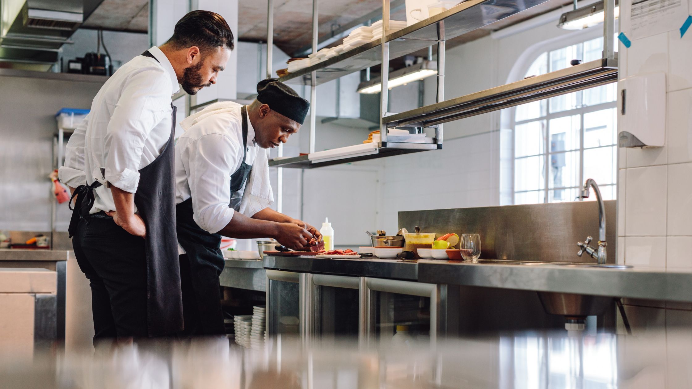Chef and assistant finishing a plated dish