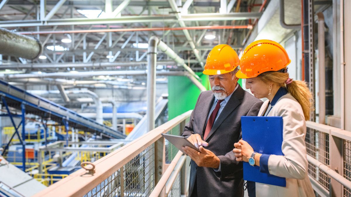 Two Manufacturing Staff Checking the Data